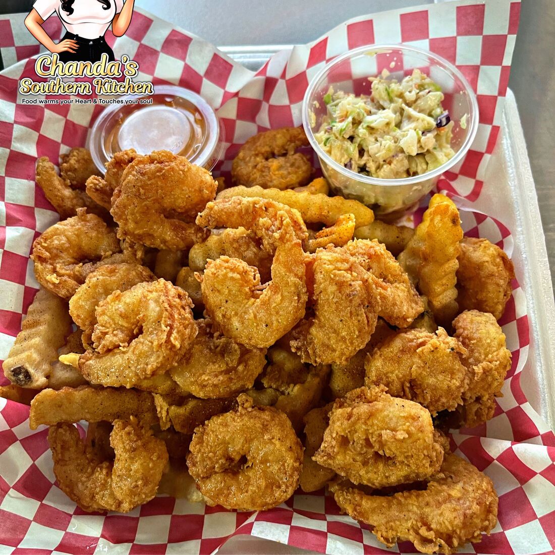 Cajun fried shrimp with coleslaw and r&eacute;moulade in a checkered basket