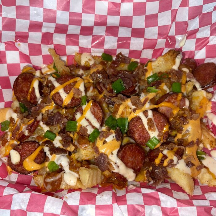 Loaded fries with sausage, cheese and sauce